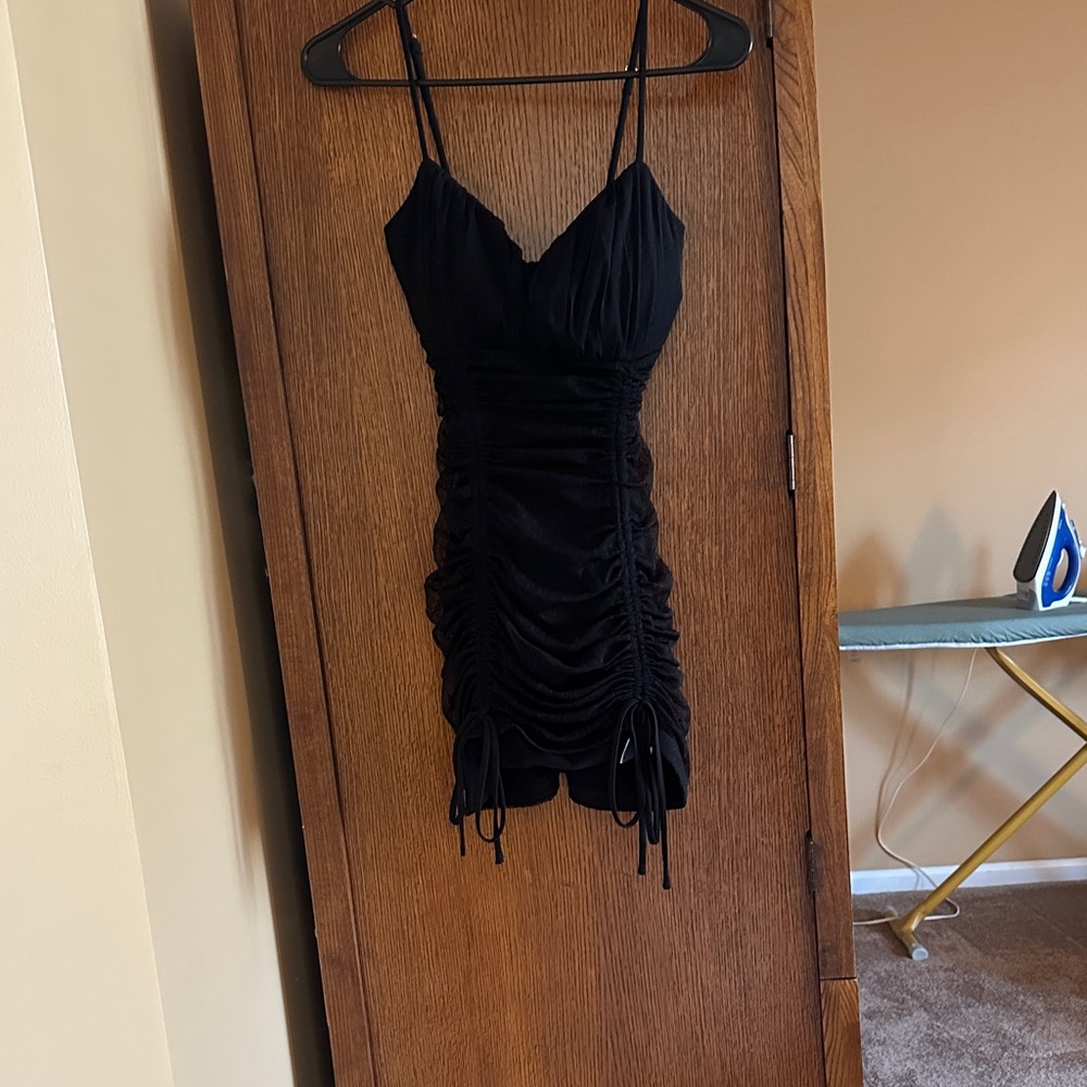 Black adjustable strap dress with ties on bottom front with lace